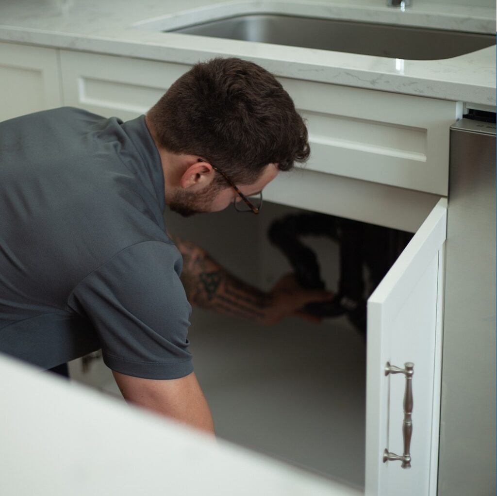 plumber working on kitchen sink